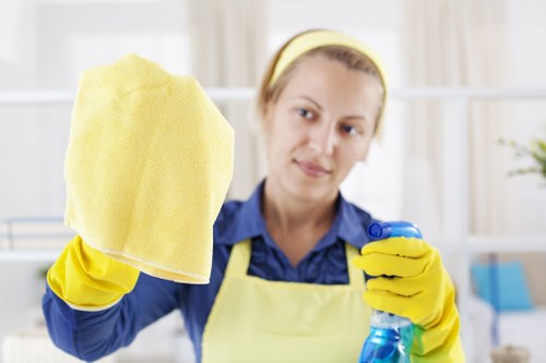 Professional office cleaner working in a Colliers Wood workplace reception area