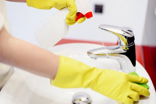 Technician applying safe carpet cleaning methods with protective equipment